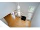 Open living room with hardwood floors, a fireplace, and plenty of natural light from the many windows at 103 Trent Woods Way, Cary, NC 27519