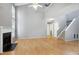 Large living room with cathedral ceiling, fireplace and hardwood floors, adjacent to carpeted stairs at 103 Trent Woods Way, Cary, NC 27519