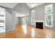 Spacious living area with a fireplace, large windows, hardwood floors, and high ceilings at 103 Trent Woods Way, Cary, NC 27519