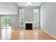 Bright living room with hardwood floors, fireplace and plenty of natural light through the windows at 103 Trent Woods Way, Cary, NC 27519