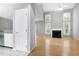 Bright living room featuring hardwood floors, fireplace, and open layout at 103 Trent Woods Way, Cary, NC 27519