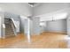 Spacious living room boasts hardwood floors, stairs to the second level, and sliding door access to outside at 103 Trent Woods Way, Cary, NC 27519