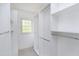 Walk-in closet with white shelving and carpeted floor at 103 Trent Woods Way, Cary, NC 27519