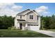 Charming two-story home with a manicured lawn, a two-car garage, and a welcoming front porch at 103 Vulcan St, Garner, NC 27529