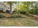 View of the private backyard, showcasing mature trees and lush greenery at 105 Bergeron Way, Cary, NC 27519