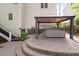 Landscaped backyard features a covered hot tub with steps leading to the home's side entrance at 105 Bergeron Way, Cary, NC 27519