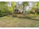 Lush backyard featuring a screened porch and beautiful landscaping, perfect for outdoor enjoyment at 105 Bergeron Way, Cary, NC 27519