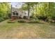 Expansive backyard with a screened-in porch and colorful flower beds, ideal for relaxation and entertaining at 105 Bergeron Way, Cary, NC 27519