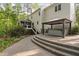 Stone patio features a covered hot tub, with stairs leading to a screened-in porch and the home's back entrance at 105 Bergeron Way, Cary, NC 27519