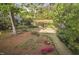 Overlooking the backyard featuring a pond with a fountain, enclosed by mature trees at 105 Bergeron Way, Cary, NC 27519
