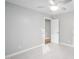 Neutrally decorated bedroom with light gray walls, and a view into an adjacent room at 105 Bergeron Way, Cary, NC 27519