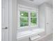 Bedroom with window seat overlooking a wooded area and pond at 105 Bergeron Way, Cary, NC 27519