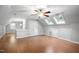 Bedroom featuring wood floors, skylights, and a large closet at 105 Bergeron Way, Cary, NC 27519