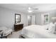 Bright bedroom featuring a ceiling fan, neutral walls, and a view into the bathroom with tub at 105 Bergeron Way, Cary, NC 27519