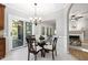 Breakfast area featuring a glass table, four chairs, sliding glass doors, and views of the fireplace at 105 Bergeron Way, Cary, NC 27519