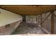 View of the home's unfinished crawlspace with brick foundation, wooden lattice, and overhead wooden beams at 105 Bergeron Way, Cary, NC 27519