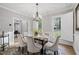 Bright dining room featuring a modern chandelier, seating for six, and natural light at 105 Bergeron Way, Cary, NC 27519