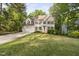 Charming two-story home with green shutters, a lush lawn, and an attached two-car garage at 105 Bergeron Way, Cary, NC 27519