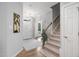 Welcoming foyer with hardwood floors, a staircase, and a view of the front door with sidelights at 105 Bergeron Way, Cary, NC 27519