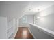 Hallway with wood floors, built in shelving, and natural lighting at 105 Bergeron Way, Cary, NC 27519