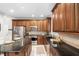 Well-equipped kitchen featuring stainless steel appliances, granite countertops, and a center island with seating at 105 Bergeron Way, Cary, NC 27519