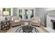 Bright living room featuring hardwood floors, screened-in porch access and modern decor at 105 Bergeron Way, Cary, NC 27519