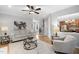 Cozy living room featuring hardwood floors, neutral paint, comfortable furniture, and seamless transition into the kitchen at 105 Bergeron Way, Cary, NC 27519