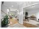 Open-concept living space with hardwood floors flowing into a dining room and a formal living room at 105 Bergeron Way, Cary, NC 27519