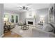 Cozy living room with a fireplace, hardwood floors, and access to a screened porch at 105 Bergeron Way, Cary, NC 27519