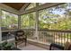A cozy screened in porch offers privacy and comfortable seating with views of nature and the backyard at 105 Bergeron Way, Cary, NC 27519