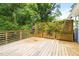 Large wooden deck offers outdoor seating and privacy planters at 107 E Hammond St, Durham, NC 27704