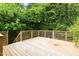 Spacious backyard deck surrounded by lush greenery at 107 E Hammond St, Durham, NC 27704