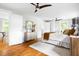 Bedroom with hardwood floors, neutral decor, ceiling fan, and area rug at 107 E Hammond St, Durham, NC 27704