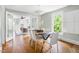 Inviting dining room featuring hardwood floors, modern decor, and an open layout with views into the living room at 107 E Hammond St, Durham, NC 27704