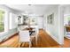 Open dining area with hardwood floors, modern decor, natural light, and an open layout leading into the kitchen at 107 E Hammond St, Durham, NC 27704