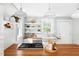 Charming kitchen with butcher block countertops, open shelving, and stainless steel appliances at 107 E Hammond St, Durham, NC 27704