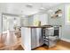 Bright kitchen with stainless steel refrigerator drawers, butcher block countertops, and stainless steel appliances at 107 E Hammond St, Durham, NC 27704