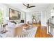 Bright living room featuring hardwood floors, stylish decor, and an open layout with views to the dining area at 107 E Hammond St, Durham, NC 27704