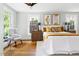 Charming main bedroom with natural lighting, stylish decor, and hardwood floors at 107 E Hammond St, Durham, NC 27704