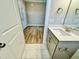 A bathroom with a white marble vanity, stainless steel hardware, and outdoor access at 1091 Fairhaven Dr # 47, Mebane, NC 27302