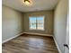 A bedroom with hardwood floors and a large window for lots of light at 1091 Fairhaven Dr # 47, Mebane, NC 27302