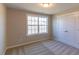 A bedroom with wall-to-wall carpeting and a closet, flooded with natural light at 1091 Fairhaven Dr # 47, Mebane, NC 27302