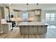 Open concept kitchen with stainless appliances, quartz countertops, and an island at 1091 Fairhaven Dr # 47, Mebane, NC 27302