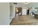 Open floor plan featuring hardwood floors, white cabinets, and access to the kitchen and stairs at 1091 Fairhaven Dr # 47, Mebane, NC 27302