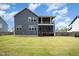 Exterior view of home featuring a sprawling backyard, a screened-in deck, and a covered patio at 1112 Valley Rose Way, Durham, NC 27712