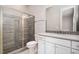 This modern bathroom has a glass-enclosed shower with updated tile and a vanity with a mosaic backsplash at 1112 Valley Rose Way, Durham, NC 27712