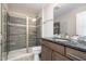 Modern bathroom featuring a glass-enclosed shower with gray tile and a granite countertop vanity at 1112 Valley Rose Way, Durham, NC 27712