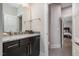 Modern bathroom with a granite vanity, stainless fixtures and door to the commode room at 1112 Valley Rose Way, Durham, NC 27712