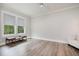 Bedroom with light-filled windows and a seating area creating a cozy space, enhanced by hardwood flooring at 1112 Valley Rose Way, Durham, NC 27712