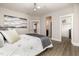 Tranquil bedroom with a luxurious bed, a walk-in closet, and ensuite bath, featuring wood-look flooring at 1112 Valley Rose Way, Durham, NC 27712